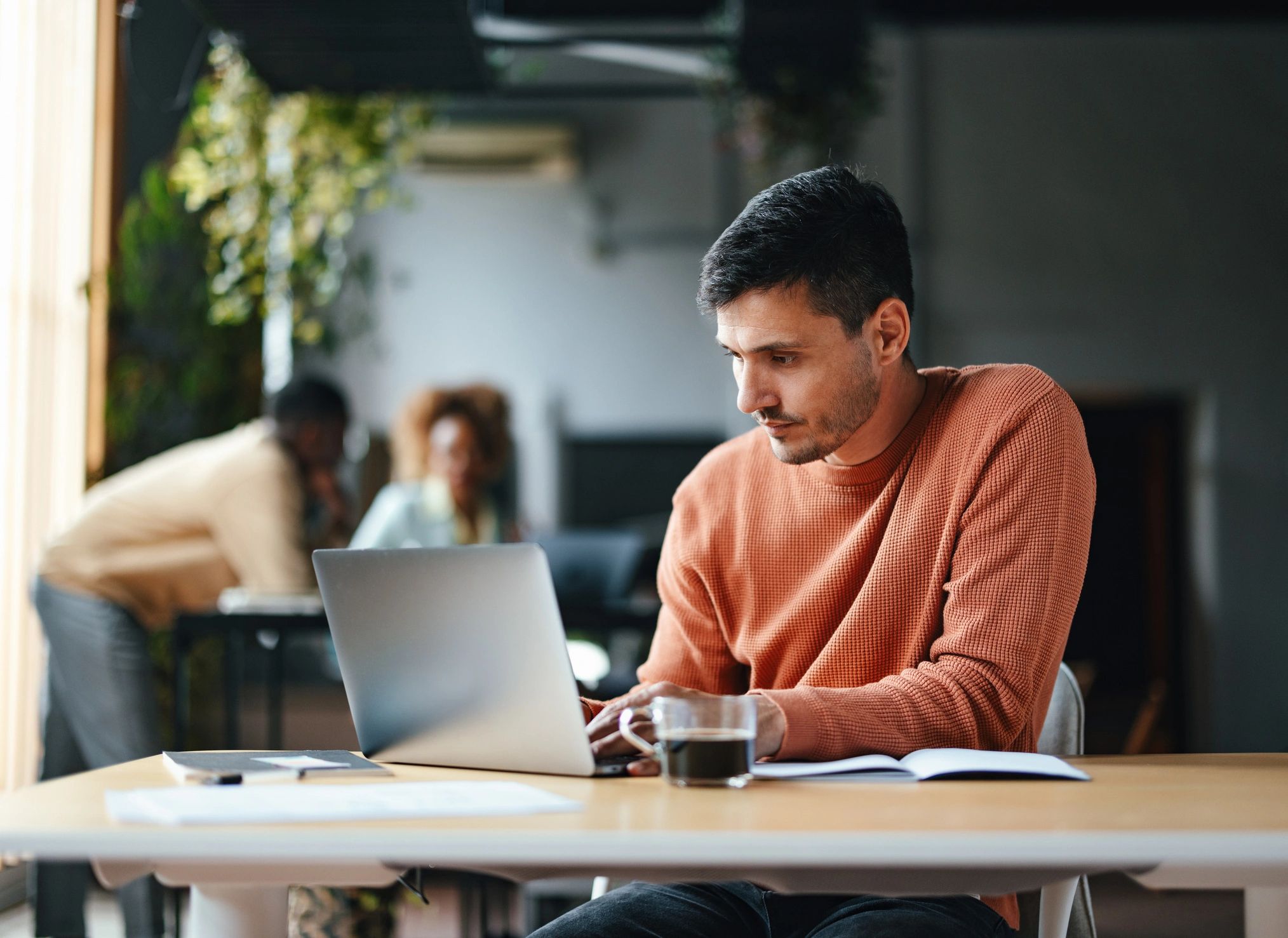 Professional working on a laptop at a desk
